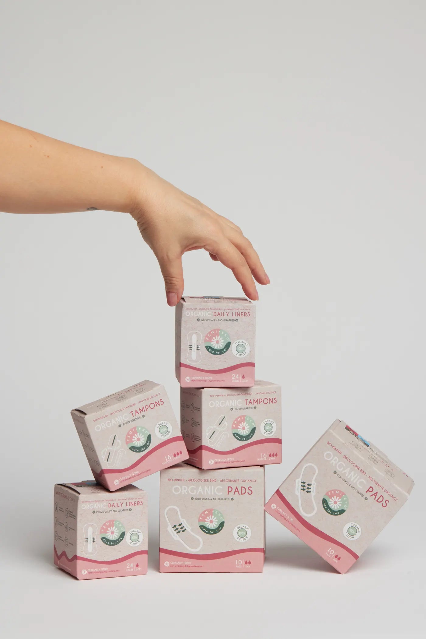 Boxes of Femieko pads, tampons and liners stacked in a product composition