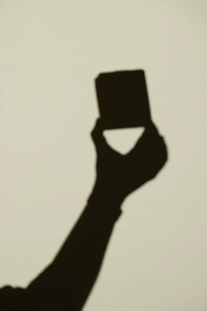 The shadow of a hand holding a Femieko product box
