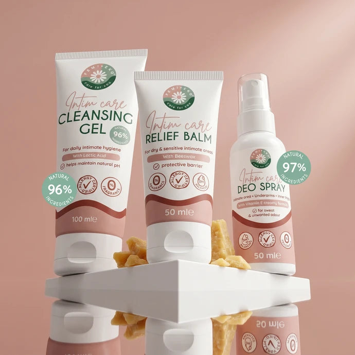 The FemiEko intimate care range: cleansing gel, deo spray and balm on a pink background.