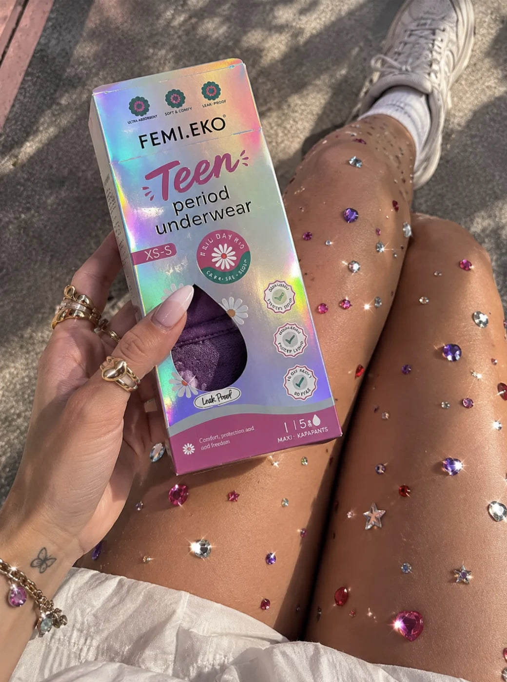 Original Femieko Teen packaging held in a hand in natural light