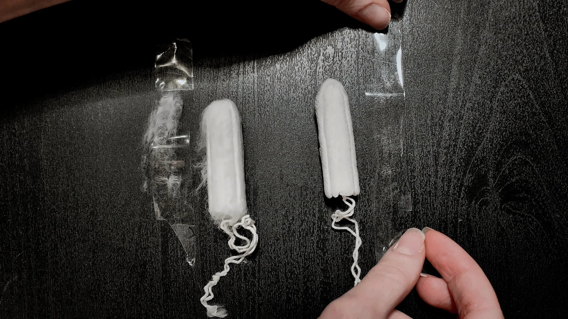 The two tampons and removed tape strips after the demonstration.